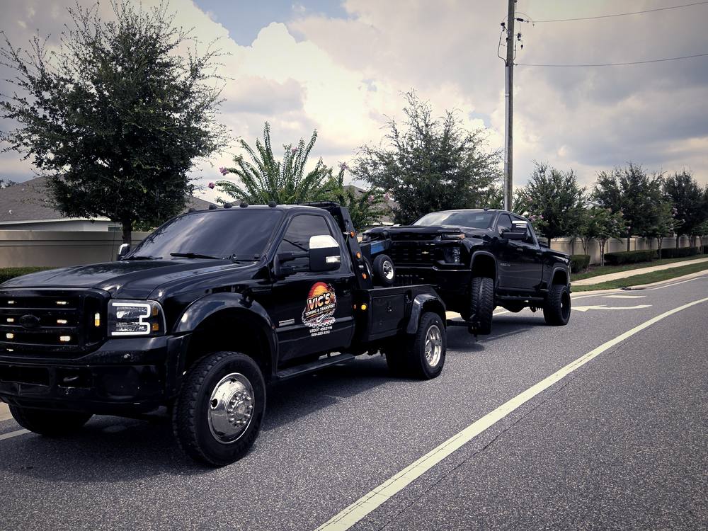 Vic's Ford wrecker with a lifted pickup on the hook.
