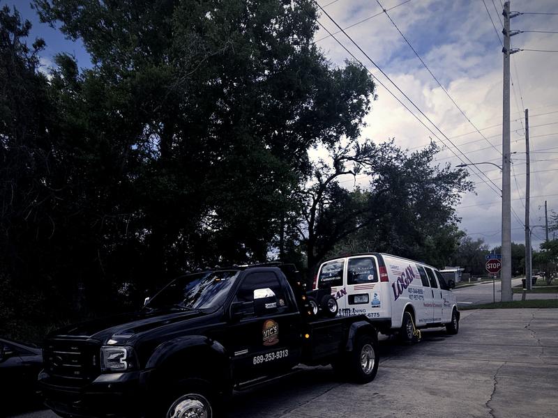 A work van being removed from a residential street.